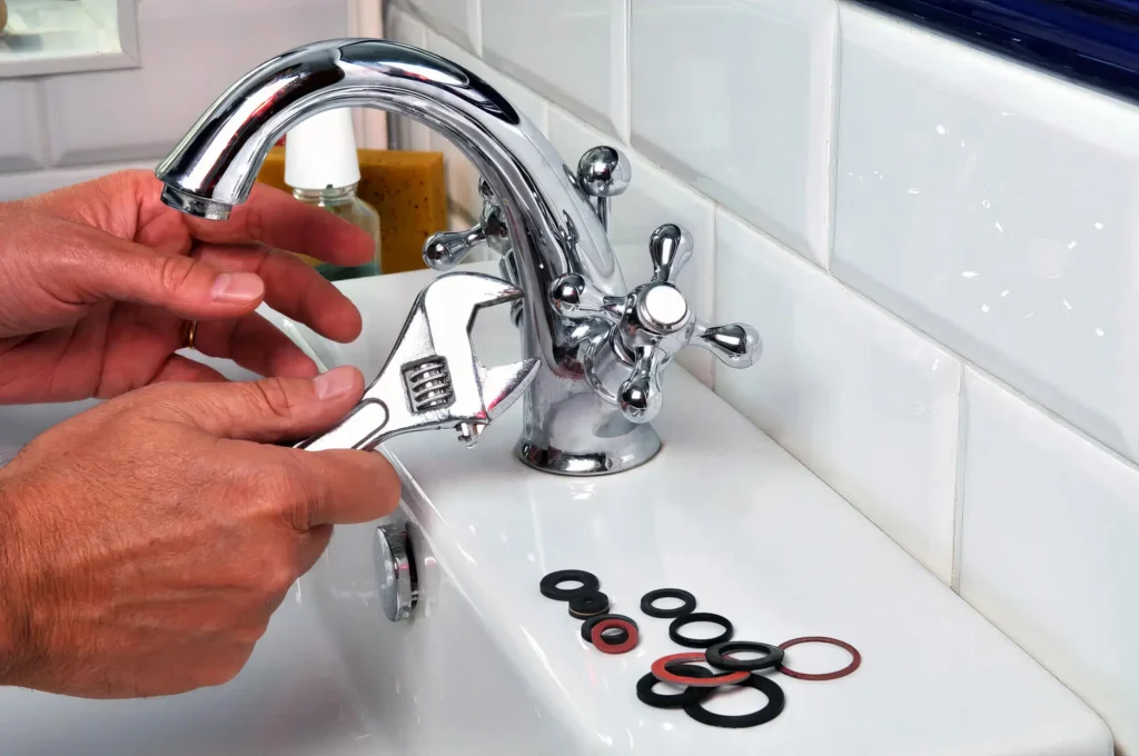 Plumber performing maintenance on a bathroom faucet in Chula Vista