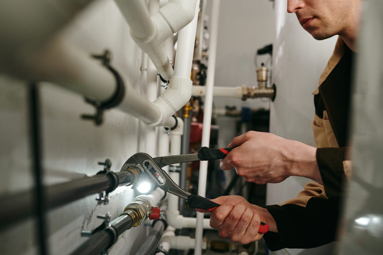 Plumbers maintaining commercial plumbing pipes in Chula Vista