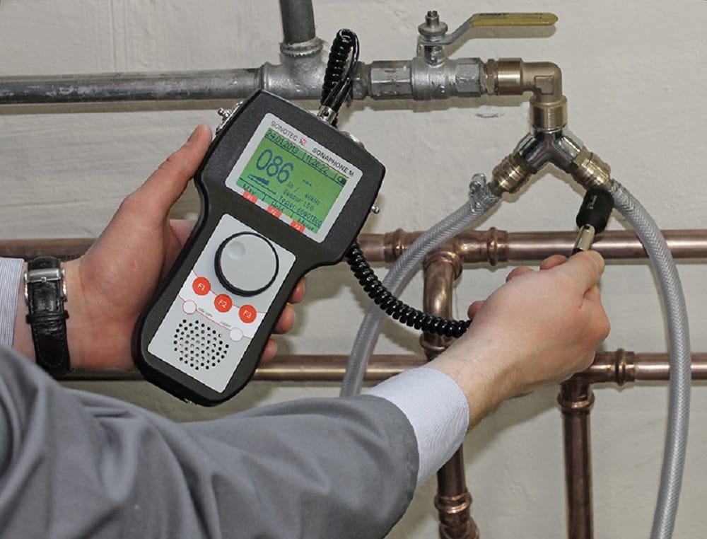 Plumber testing pipes with electronic leak detection equipment in Chula Vista