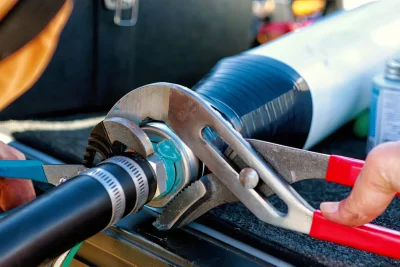 Technician tightening an industrial pipe connection in Chula Vista