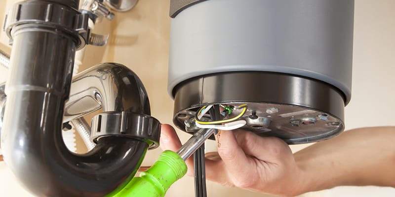 Technician repairing the heating element of a water heater in Chula Vista