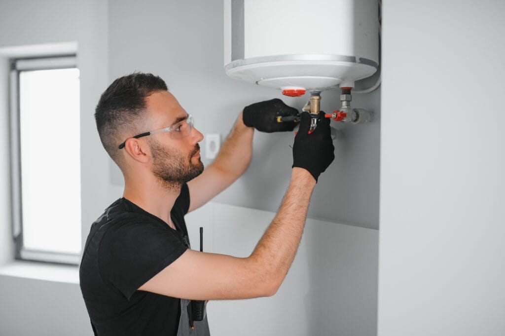 Technician performing water heater maintenance in Chula Vista
