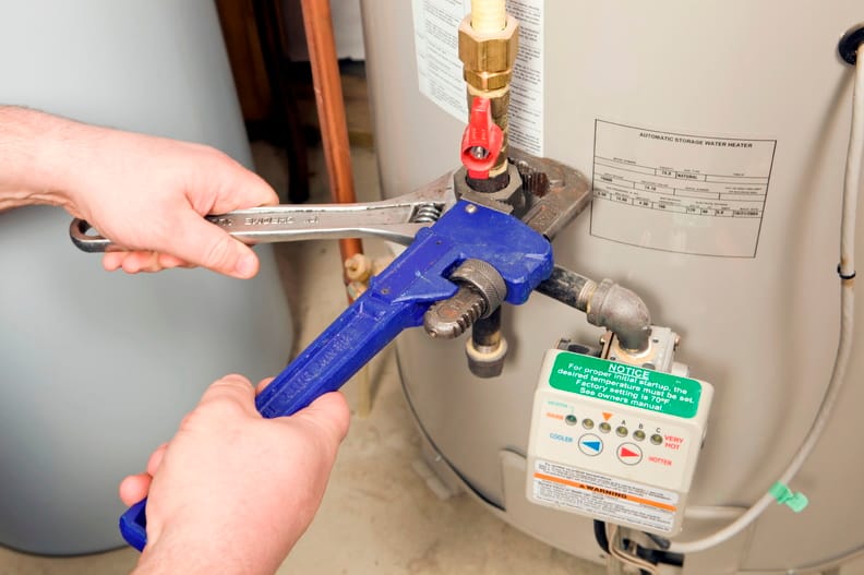 Plumber repairing a water heater valve in Chula Vista